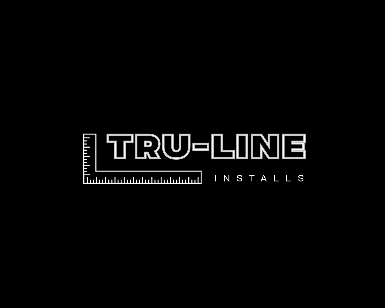 Logo for Tru-Line Installs, a construction company, featuring a ruler and text in white on a black background.